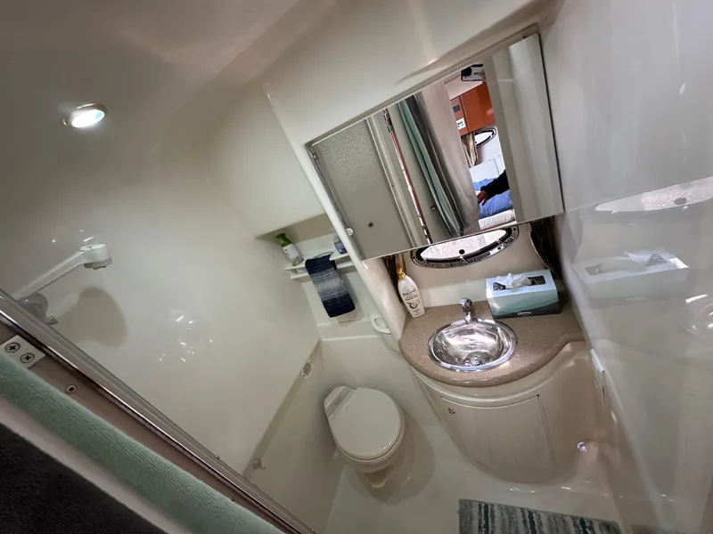 Slide: The Image of 2004 Formula 34 PC yacht bathroom with sink, toilet, and mirror. - 24