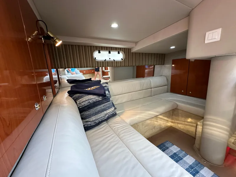 Slide: The Image of Luxurious interior of a 2004 Formula 34 PC yacht with plush seating and elegant wood finishes. - 26
