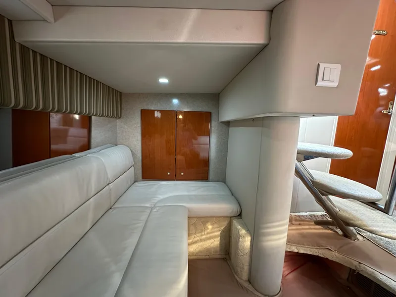 Slide: The Image of Interior of 2004 Formula 34 PC yacht with beige seating and wooden cabinetry. - 27