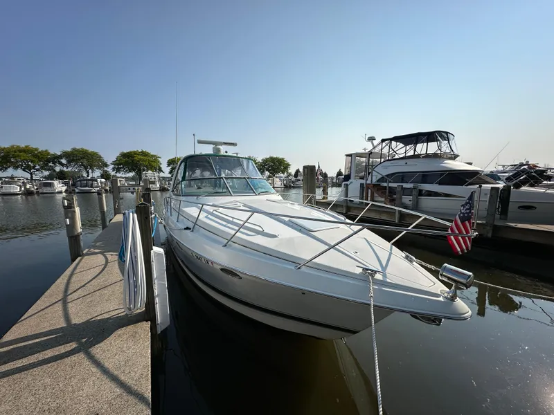 Slide: The Image of 2004 Formula 34 PC yacht docked at marina with American flag, clear sky background. - 33