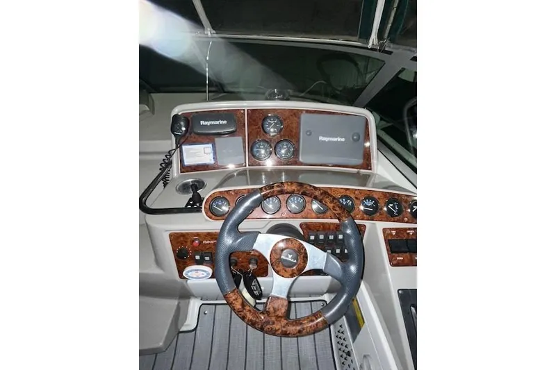 Slide: The Image of 2004 Formula 34 Performance Cruiser dashboard with Raymarine navigation system and wood accents. - 34