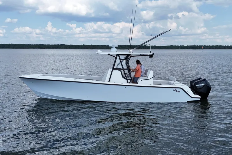 The Image of 2023 SeaVee 320B boat on calm water under a cloudy sky. - 0