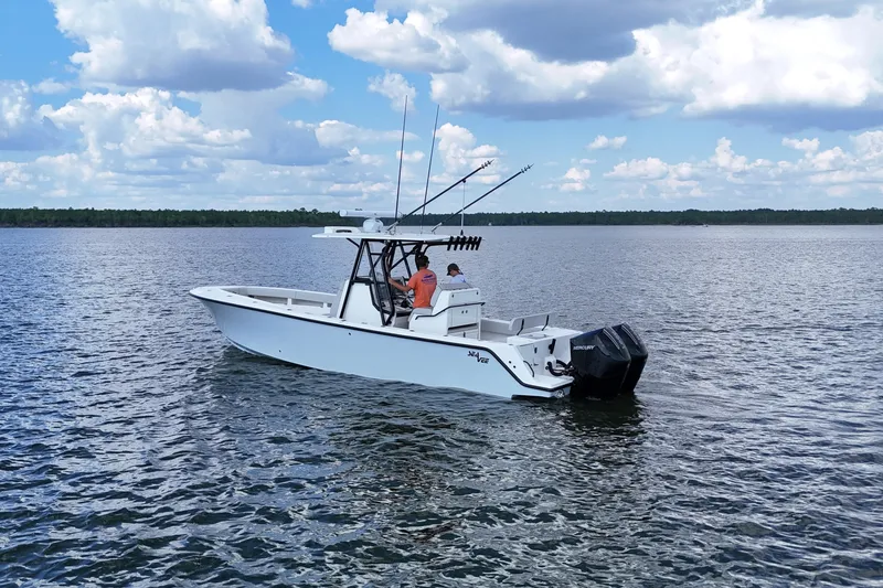 Slide: The Image of 2023 SeaVee 32 boat on calm water under a partly cloudy sky. - 1