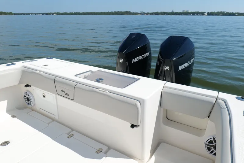 Slide: The Image of 2023 SeaVee 32 boat with dual Mercury engines on calm water. - 10