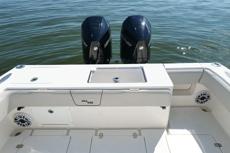 Slide: The Image of 2023 SeaVee 32 boat with dual Mercury engines on calm water. - 15