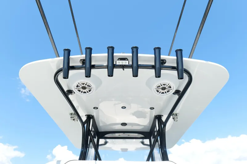 Slide: The Image of 2023 SeaVee 32 boat top view with rod holders against blue sky. - 17