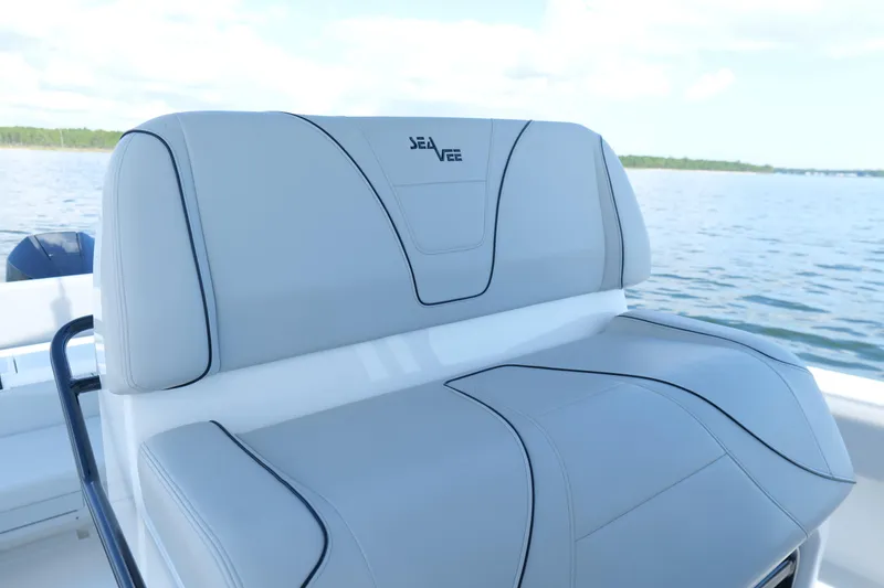 Slide: The Image of 2023 SeaVee 32 boat seat with sleek design on calm water. - 18