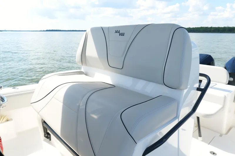 Slide: The Image of 2023 SeaVee 32 boat with sleek seating, on calm waters under a blue sky. - 19