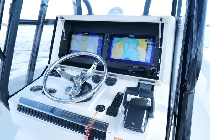 Slide: The Image of 2023 SeaVee 32 boat dashboard with navigation screens and steering wheel. - 22