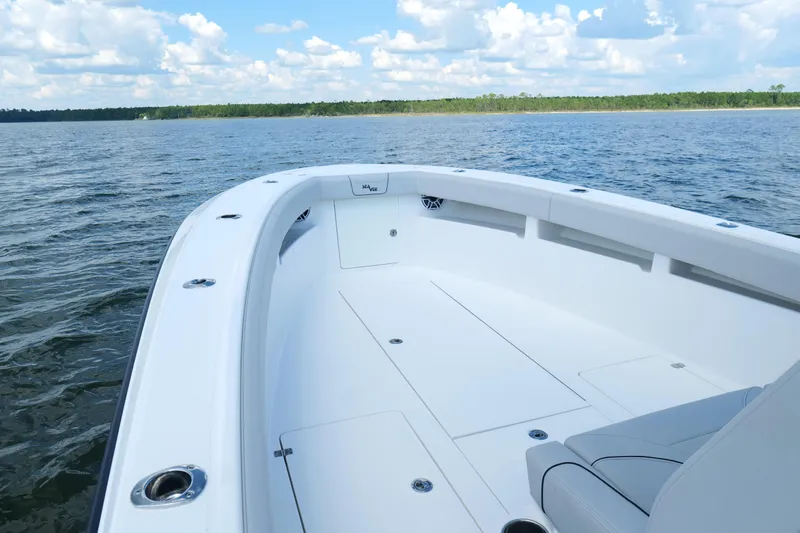 Slide: The Image of 2023 SeaVee 32 boat on calm water, featuring spacious deck and sleek design. - 28