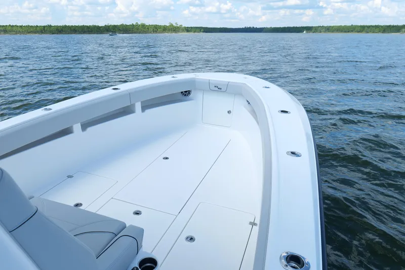 Slide: The Image of 2023 SeaVee 32 boat on calm water, showcasing spacious deck and sleek design. - 29