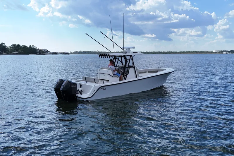 Slide: The Image of 2023 SeaVee 32 boat on calm water under a partly cloudy sky. - 3