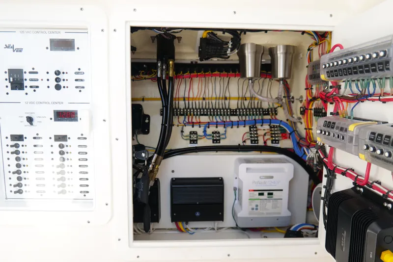 Slide: The Image of Electrical control panel of a 2023 SeaVee 32 boat, showcasing wiring and components. - 33