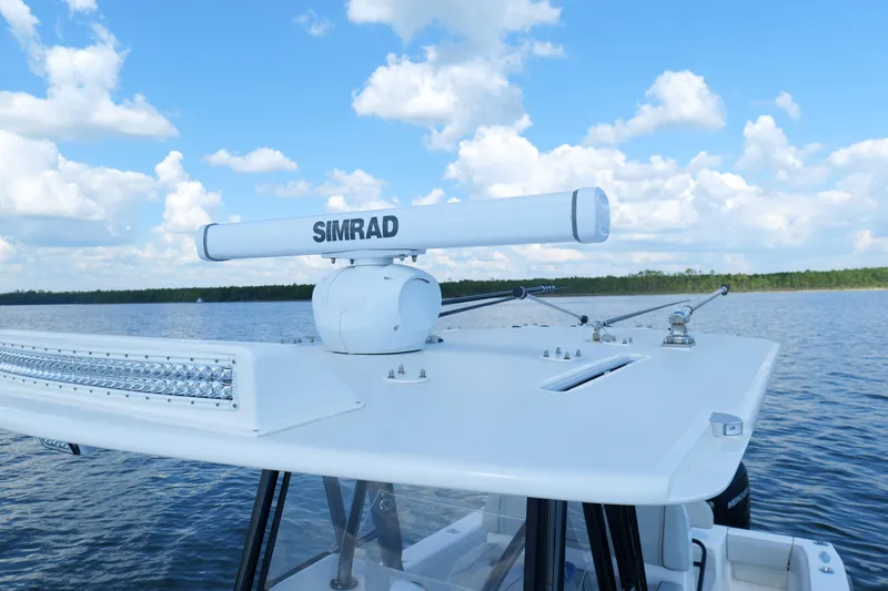 Slide: The Image of 2023 SeaVee 32 boat with Simrad radar on calm water under blue sky. - 35