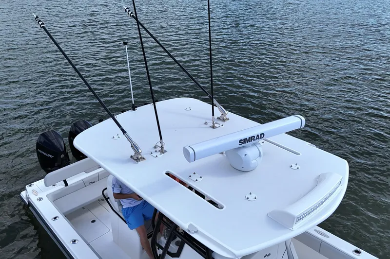 Slide: The Image of 2023 SeaVee 32 boat with Simrad radar and fishing rods on calm water. - 36