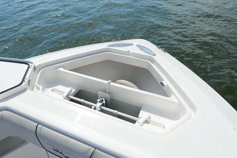 Slide: The Image of 2023 SeaVee 32 boat anchor compartment, open on calm water. - 40