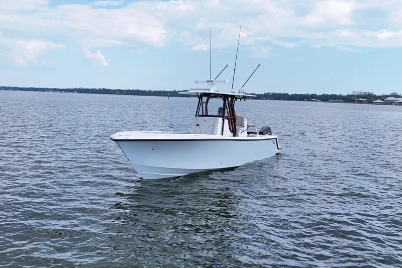 Slide: The Image of 2023 SeaVee 32 boat on calm water under a partly cloudy sky. - 7