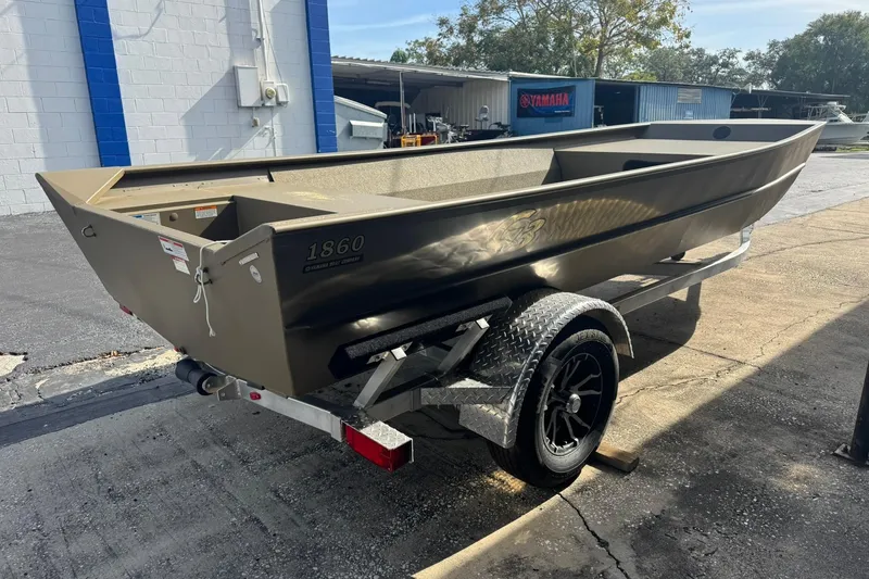 Slide: The Image of 2026 G3 Gator Tough 1860 VBW boat on trailer, parked outdoors. - 3