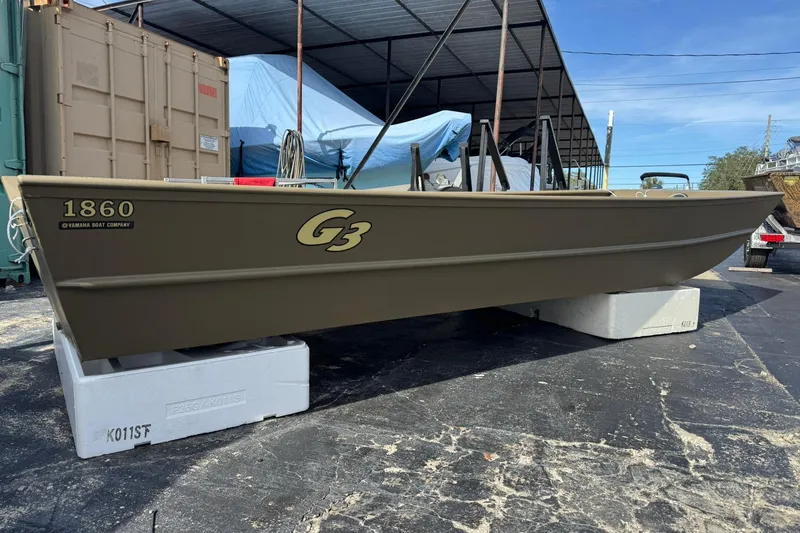 Slide: The Image of 2026 G3 Gator Tough 1860 VBW boat displayed outdoors on a stand. - 5