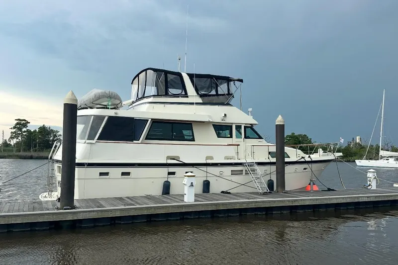 The Image of 1987 Hatteras 54 Motor Yacht cruising on open water under clear skies. - 0