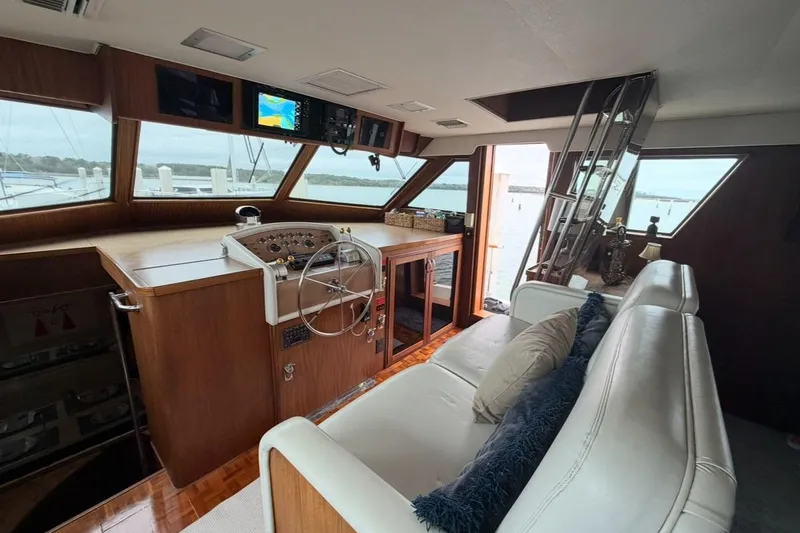 Slide: The Image of Interior of 1987 Hatteras 54 Motor Yacht with elegant dining area and modern art. - 11