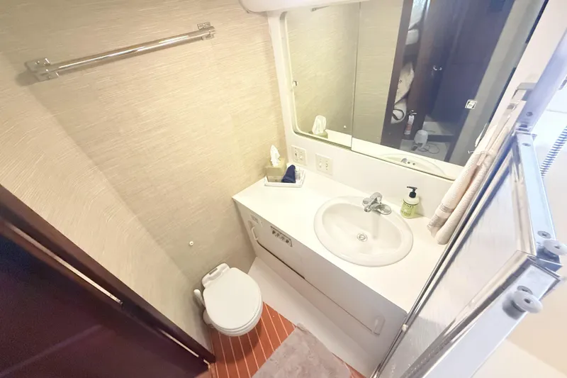 Slide: The Image of Bathroom interior of 1987 Hatteras 54 Motor Yacht with sink, toilet, and mirror. - 16