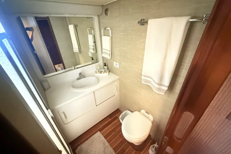 Slide: The Image of Bathroom interior of 1987 Hatteras 54 Motor Yacht with sink, mirror, and towel rack. - 21