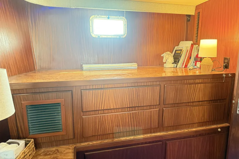 Slide: The Image of 1987 Hatteras 54 Motor Yacht interior with wooden cabinetry and books. - 25