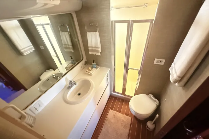 Slide: The Image of Bathroom interior of 1987 Hatteras 54 Motor Yacht with sink, mirror, and shower. - 26