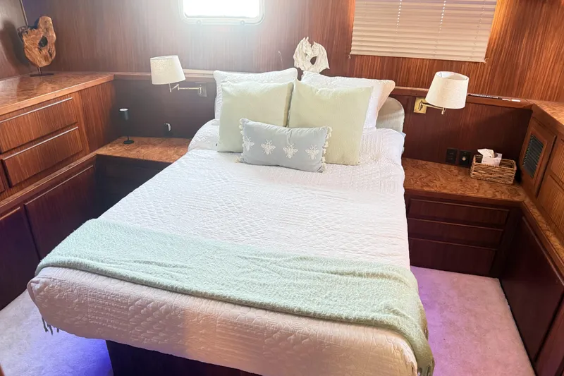 Slide: The Image of Cozy bedroom interior of 1987 Hatteras 54 Motor Yacht with elegant wood finish. - 28