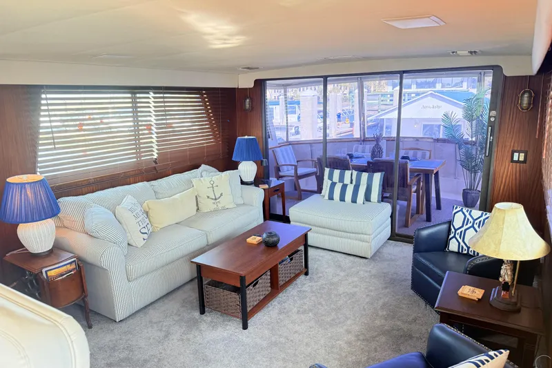 Slide: The Image of Interior of 1987 Hatteras 54 Motor Yacht with cozy seating and nautical decor. - 29