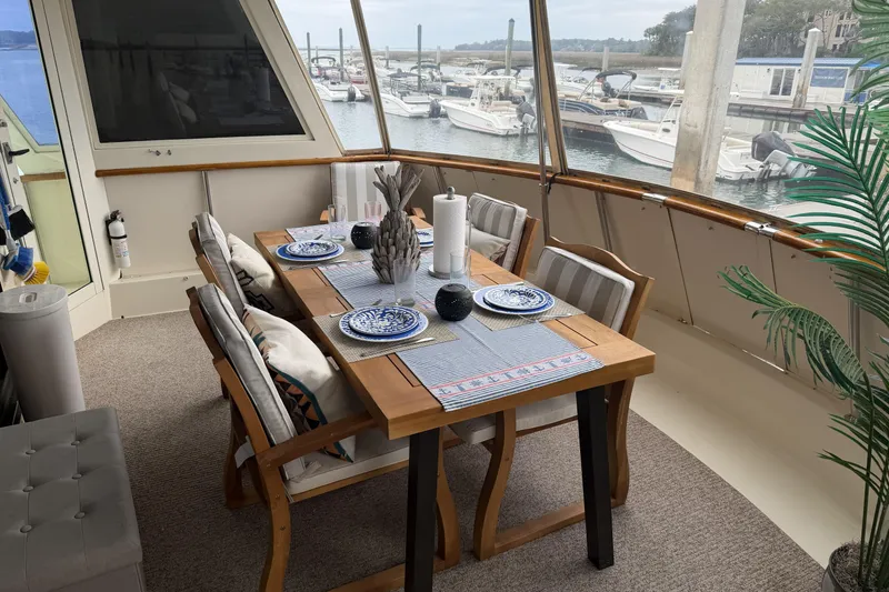 Slide: The Image of 1987 Hatteras 54 Motor Yacht cruising on open water under clear skies. - 3