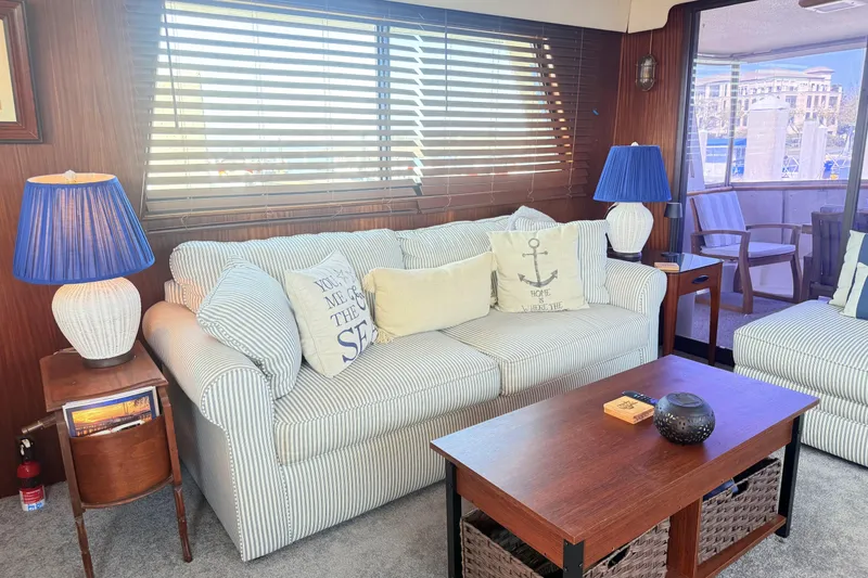 Slide: The Image of Interior of 1987 Hatteras 54 Motor Yacht with cozy seating and nautical decor. - 30