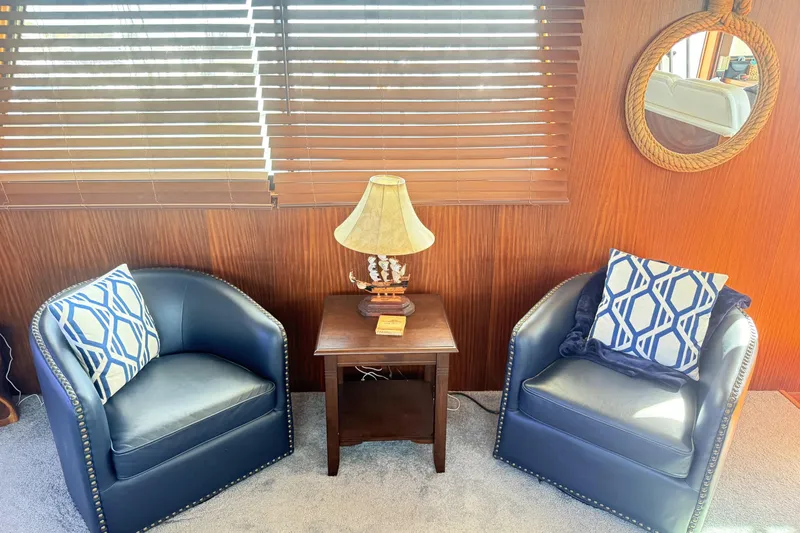 Slide: The Image of Interior of 1987 Hatteras 54 Motor Yacht with chairs, table, and nautical decor. - 31