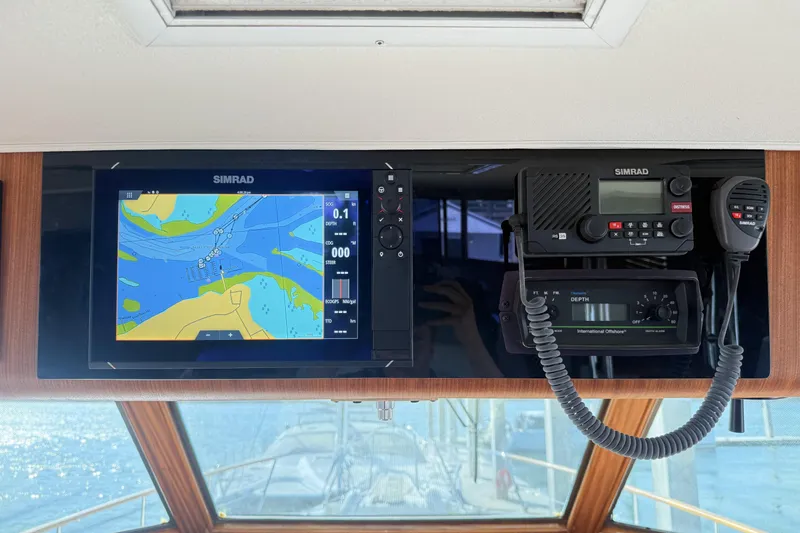 Slide: The Image of 1987 Hatteras 54 Motor Yacht helm with Simrad navigation and communication equipment. - 34