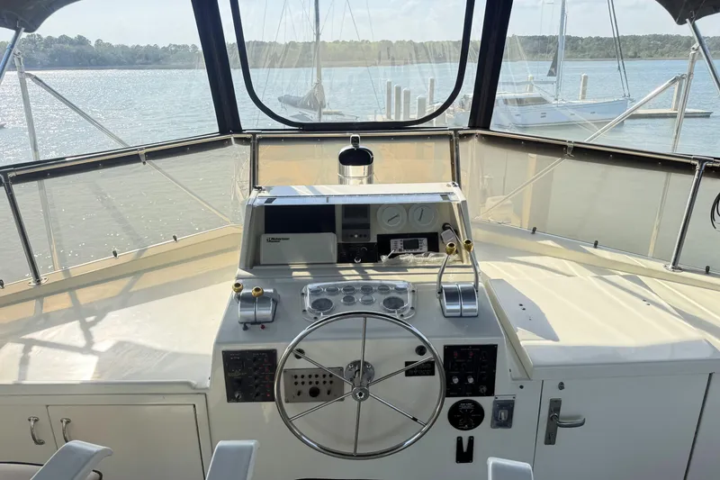 Slide: The Image of Helm of 1987 Hatteras 54 Motor Yacht with steering wheel and control panel. - 36