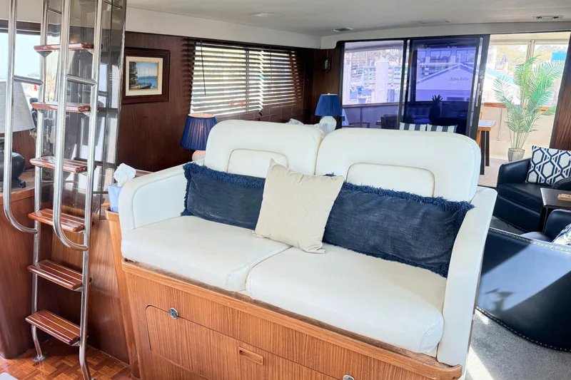 Slide: The Image of Interior of 1987 Hatteras 54 Motor Yacht with white seating and wooden accents. - 40