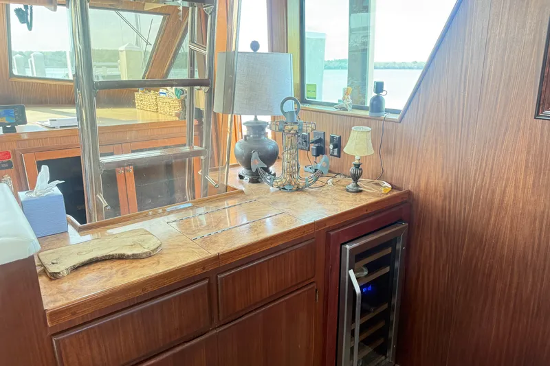 Slide: The Image of Interior of 1987 Hatteras 54 Motor Yacht with wooden cabinetry and decorative lamps. - 41