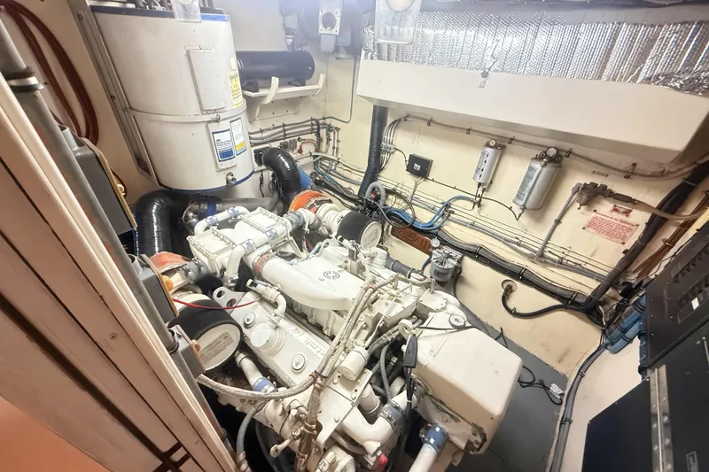 Slide: The Image of Engine room of 1987 Hatteras 54 Motor Yacht, showcasing mechanical components and wiring. - 47