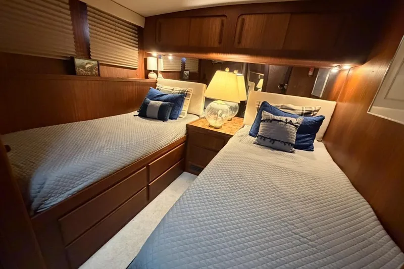 Slide: The Image of 1987 Hatteras 54 Motor Yacht on calm ocean waters, front view. - 5