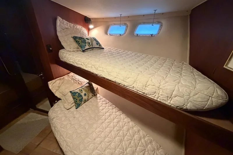 Slide: The Image of 1987 Hatteras 54 Motor Yacht on calm sea under clear sky. - 6