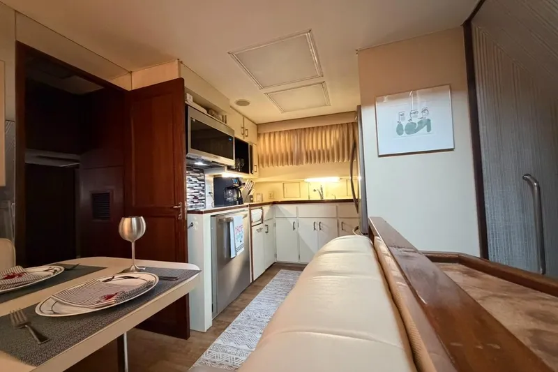 Slide: The Image of 1987 Hatteras 54 Motor Yacht cruising on open water, aerial view. - 9