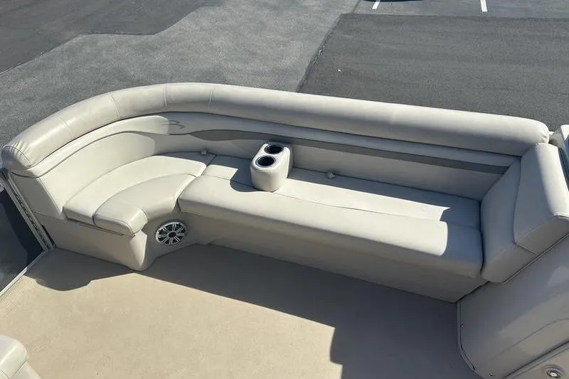 Slide: The Image of 2015 Bennington 22 SLX boat interior with beige seating and cup holders. - 12