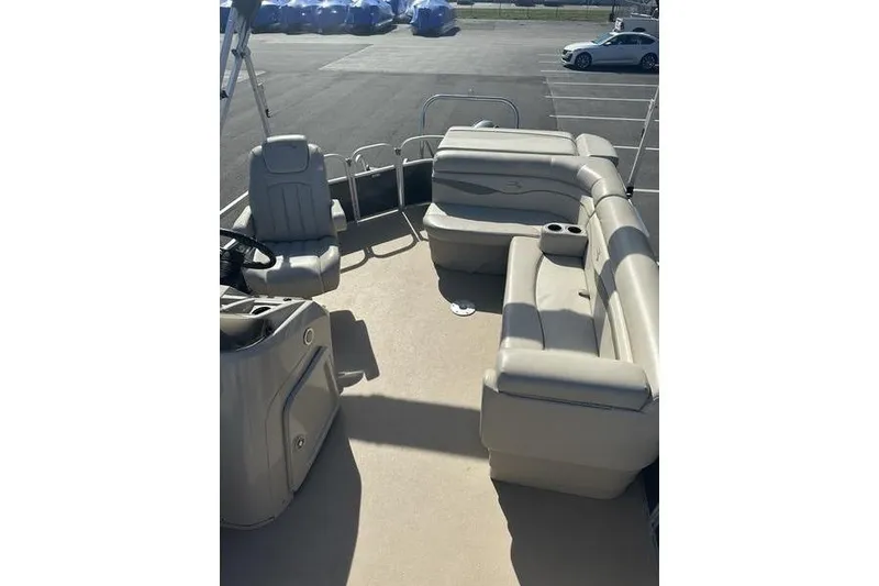 Slide: The Image of 2015 Bennington 22 SLX pontoon boat with beige seating and spacious deck layout. - 13