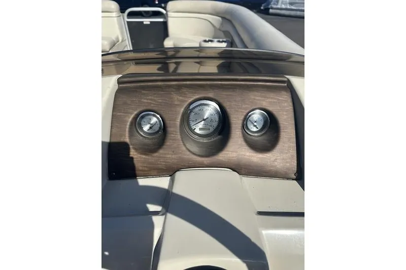 Slide: The Image of Dashboard of a 2015 Bennington 22 SLX boat with gauges and seating. - 14