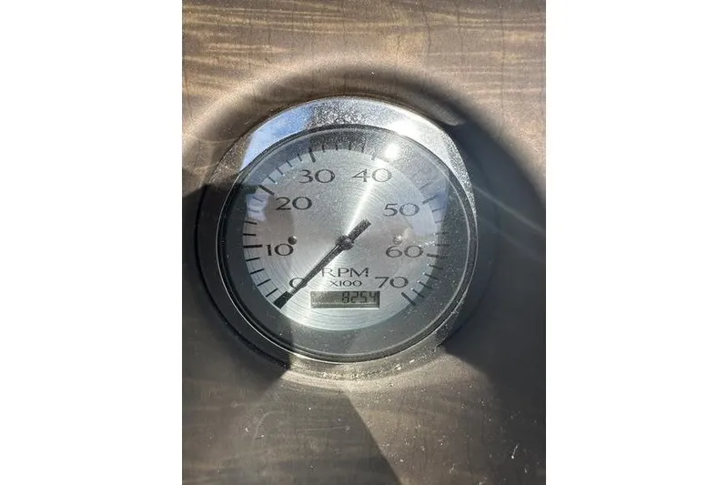 Slide: The Image of Close-up of 2015 Bennington 22 SLX RPM gauge displaying 825 hours. - 18