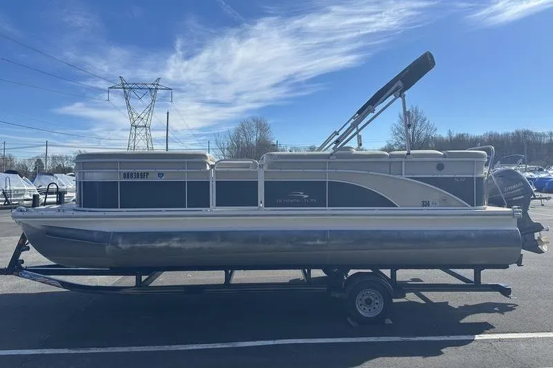 Slide: The Image of 2015 Bennington 22 SLX pontoon boat on trailer under clear blue sky. - 3