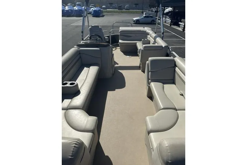 Slide: The Image of 2015 Bennington 22 SLX pontoon boat interior with beige seating and spacious layout. - 8