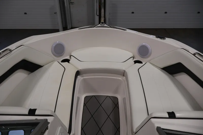 Slide: The Image of 2016 Yamaha Boats SX190 interior with white seating and built-in speakers. - 10
