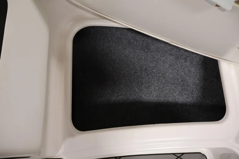 Slide: The Image of 2016 Yamaha Boats SX190 interior storage compartment with carpeted flooring. - 11